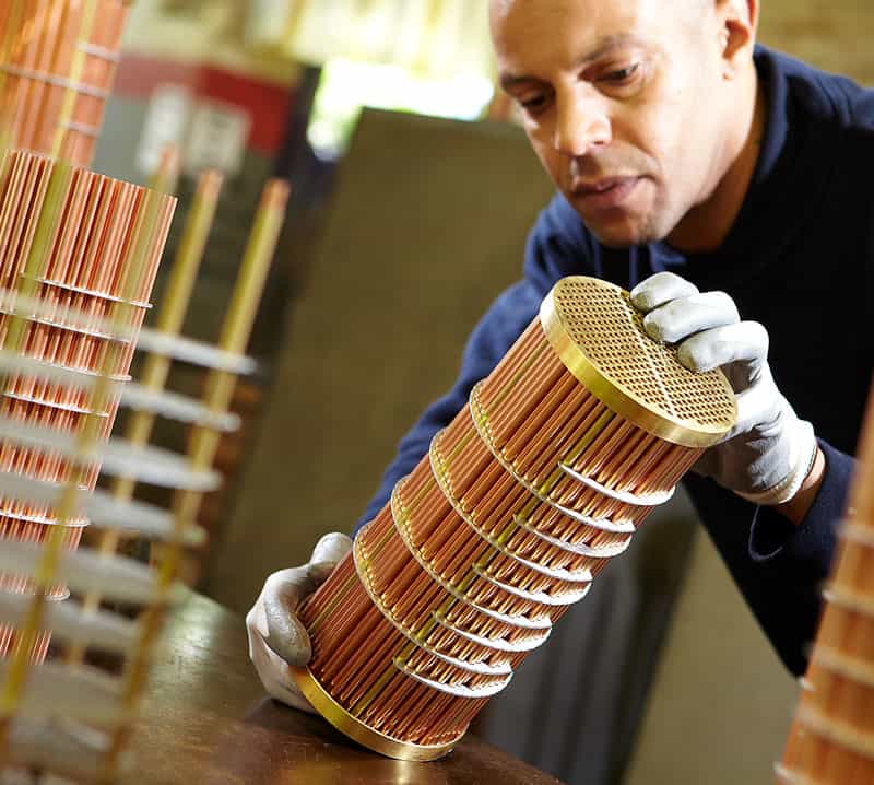 Close up shot of Grayson Thermal Systems employee reviewing tube heat exchanger
